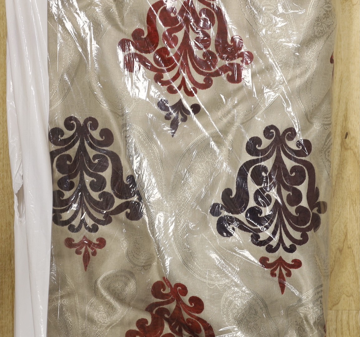 A large pair of silver brocaded curtains, with a woven paisley tear drop motif and large all over plum cut velvet Fleur-de-lis motifs, together with matching corded and tasselled tie backs.